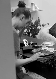 Paige at work learning how to tie box bows at Glow Cosmetique