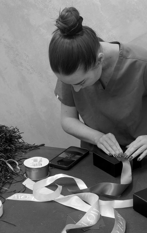 Paige at work on YouTube learning how to tie box bows at Glow Cosmetique